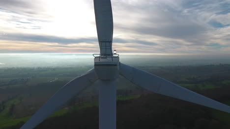 wind-turbine-inspection-close-aerial-drone-shot-in-France.-Misty-horizon-morning